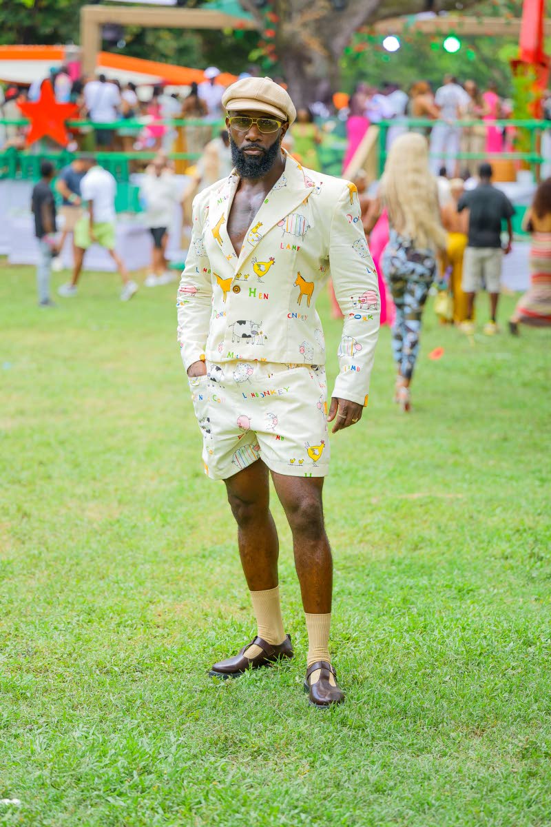 Stylist Steven Morgan showcases his own design, pairing his shorts suit with a newsboy cap and matching crew socks.