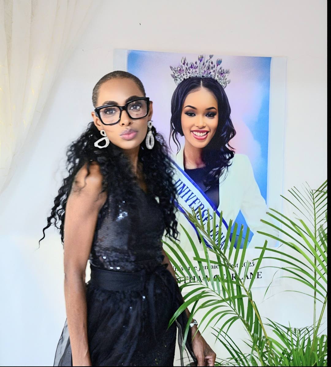 Hannah Sheree (left), pageant director, Miss Universe Jamaica Westmoreland, poses in front of a picture of reigning queen Miss Universe Jamaica West 2025 Samantha McFarlane.