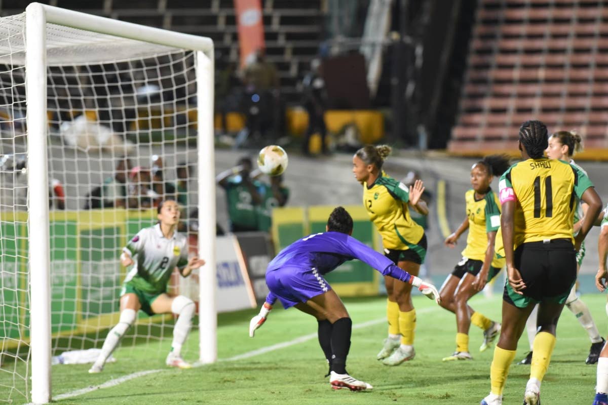 Reggae Girlz captain, Khadija Shaw (right), looks on as her header goes toward Guyana’s Rylee Traicoff during their Concacaf W Qualifier inside the National Stadium yesterday.
