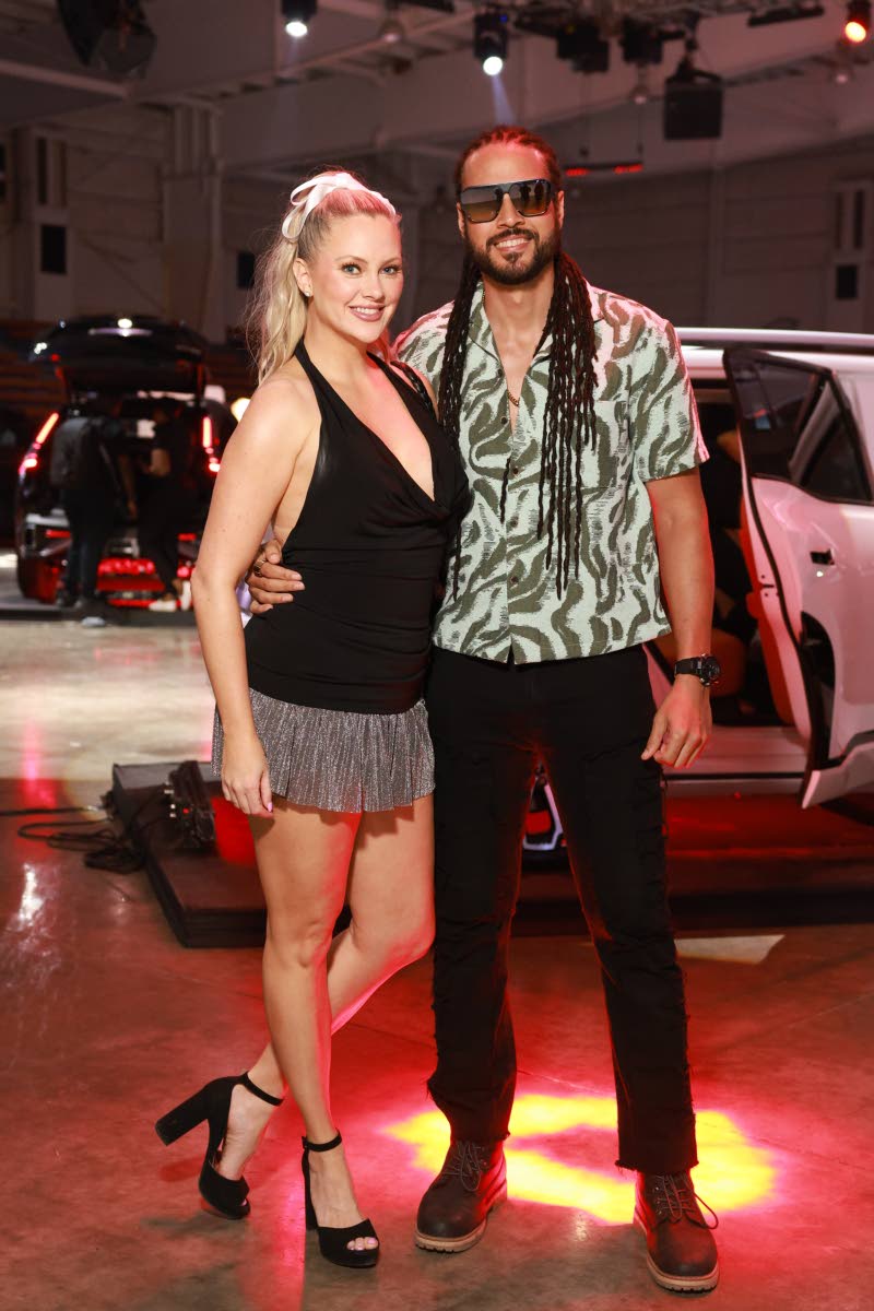 Reggae artiste Simon ‘Skygrass’ Bowden is spotted with fiancée Nicole Arbour, who wears a halter mini and strappy block heels.