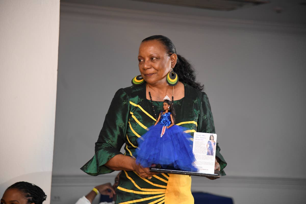 LEFT: Beverley Robotham-Reynolds of Island Dolls holds the doll she made of reigning Miss Jamaica World Neveah Allen before presenting it to her on stage.
