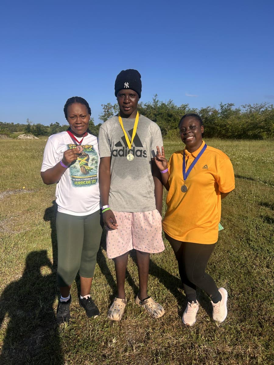 First‑place finisher in the adult walking category of the Sheffield Primary 2K walk/run, Javier Godfrey (centre), is joined by second‑place finisher Raneisha Patterson (right) and Sherika Reynolds (left), who placed third, following the race on Friday.