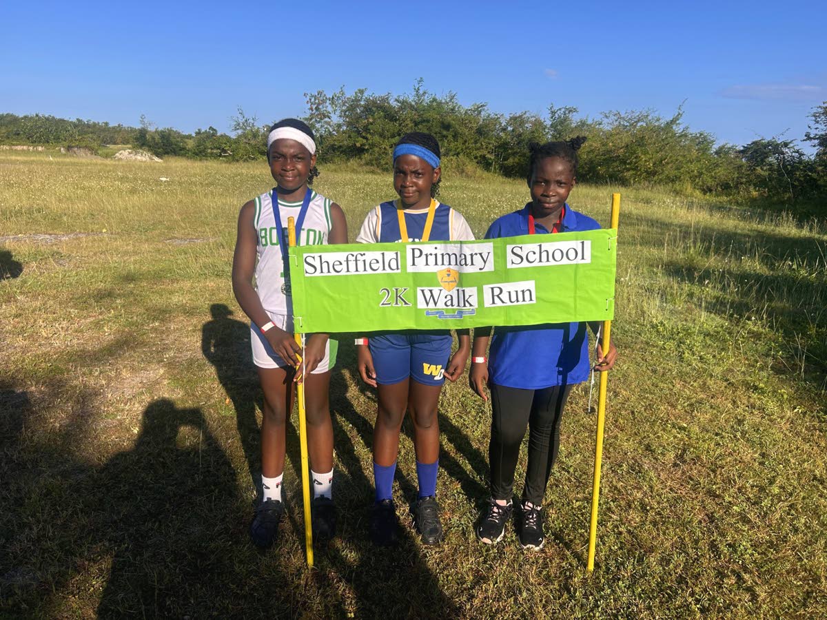 Girls’ category winner Kevece Richards is joined by her sister Kavece Richards, who placed second, and Deloris Bennett, who finished third, following the 2K run.