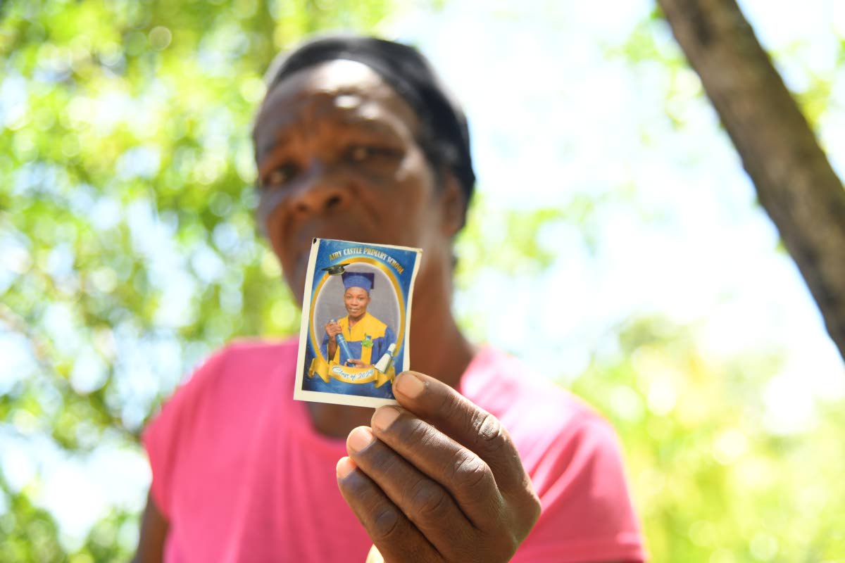 Vinnella Sutherland holds a photograph of her 13-year-old grandson, Kland Doyle, who was fatally stabbed, reportedly by a peer, on Monday in St Thomas. 