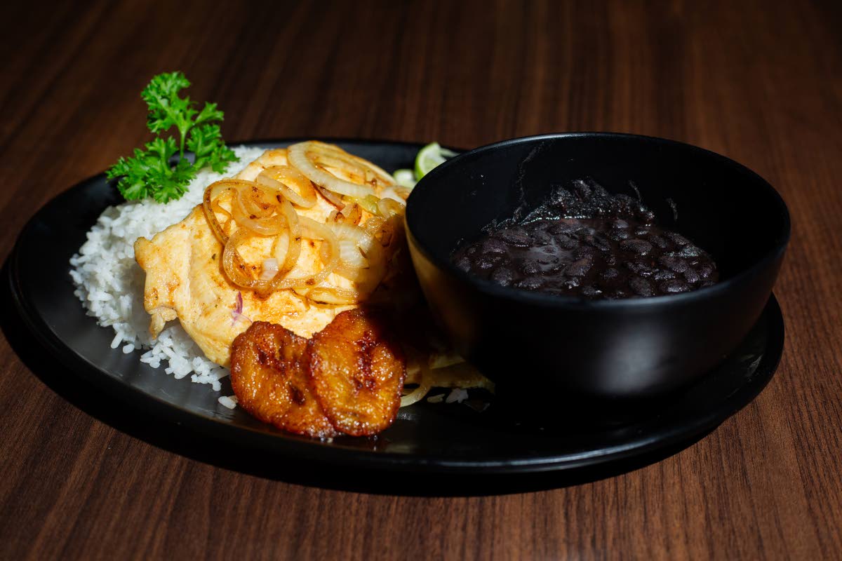 The bistec de pollo or chicken steak is a popular Cuban dish paired with black beans and white rice.
