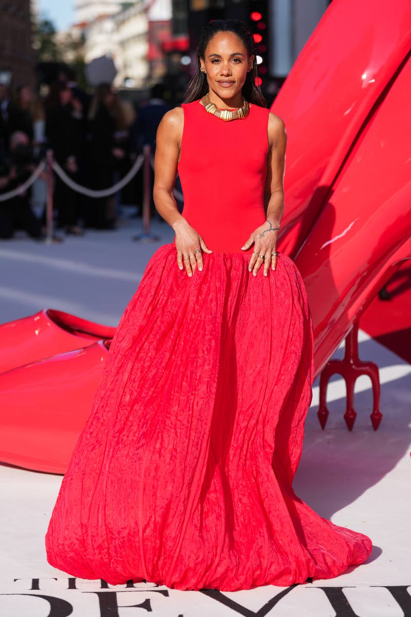 Footballer-turned-broadcaster Alex Scott makes a striking entrance in sweeping red.