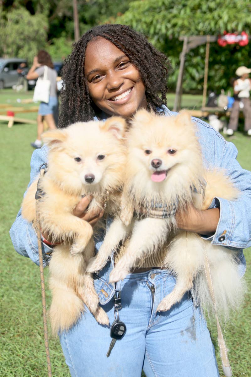 Double the fun, double the fluff as Talitha Thomas poses with her Pomeranian–Shih Tzu mix pups, Luna (left) and Sirius.