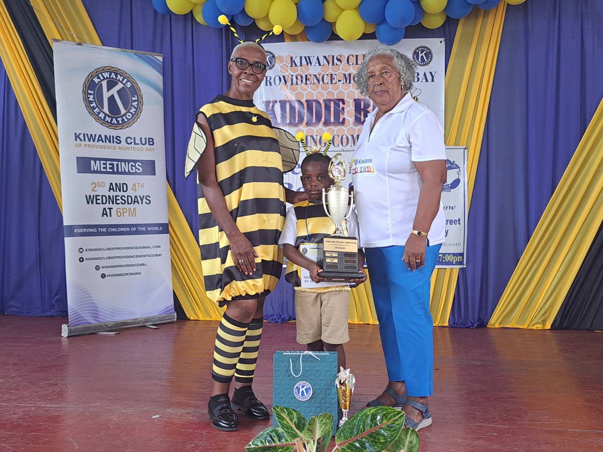 Kaleo Thomas (centre), a five-year-old student of Mount Alvernia Preparatory and Kindergarten in Montego Bay, St James, poses with his first-place trophy for winning the Kiwanis Club of Providence Montego Bay’s 10th annual Kiddie Bee Spelling Competition