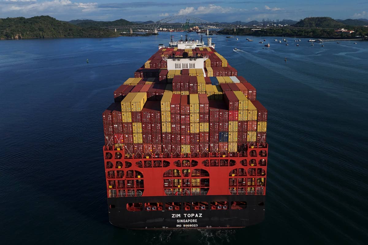 Cargo containers are stacked on a cargo ship moving through the Panama Canal, at sunrise in Panama City, Wednesday, March 25, 2026. (AP Photo/Matias Delacroix)