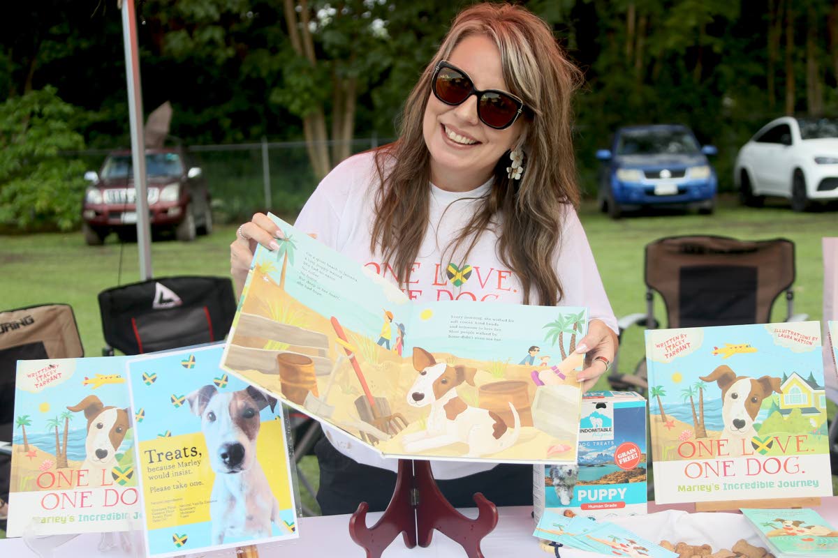 Stacey Tarrant, author of ‘One Love. One Dog. Marley’s Incredible Journey’, show pages from the book at the official launch during Happy Tails’ Yappy Hour on Sunday, highlighting the moment she and her family first spotted Marley on a beach during 