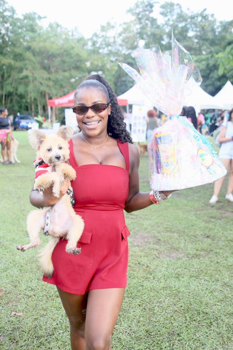 Danielle McCalla, chief creative officer at DCM Media, holds her Shih-Pom, William, following his win in the doggie costume contest.