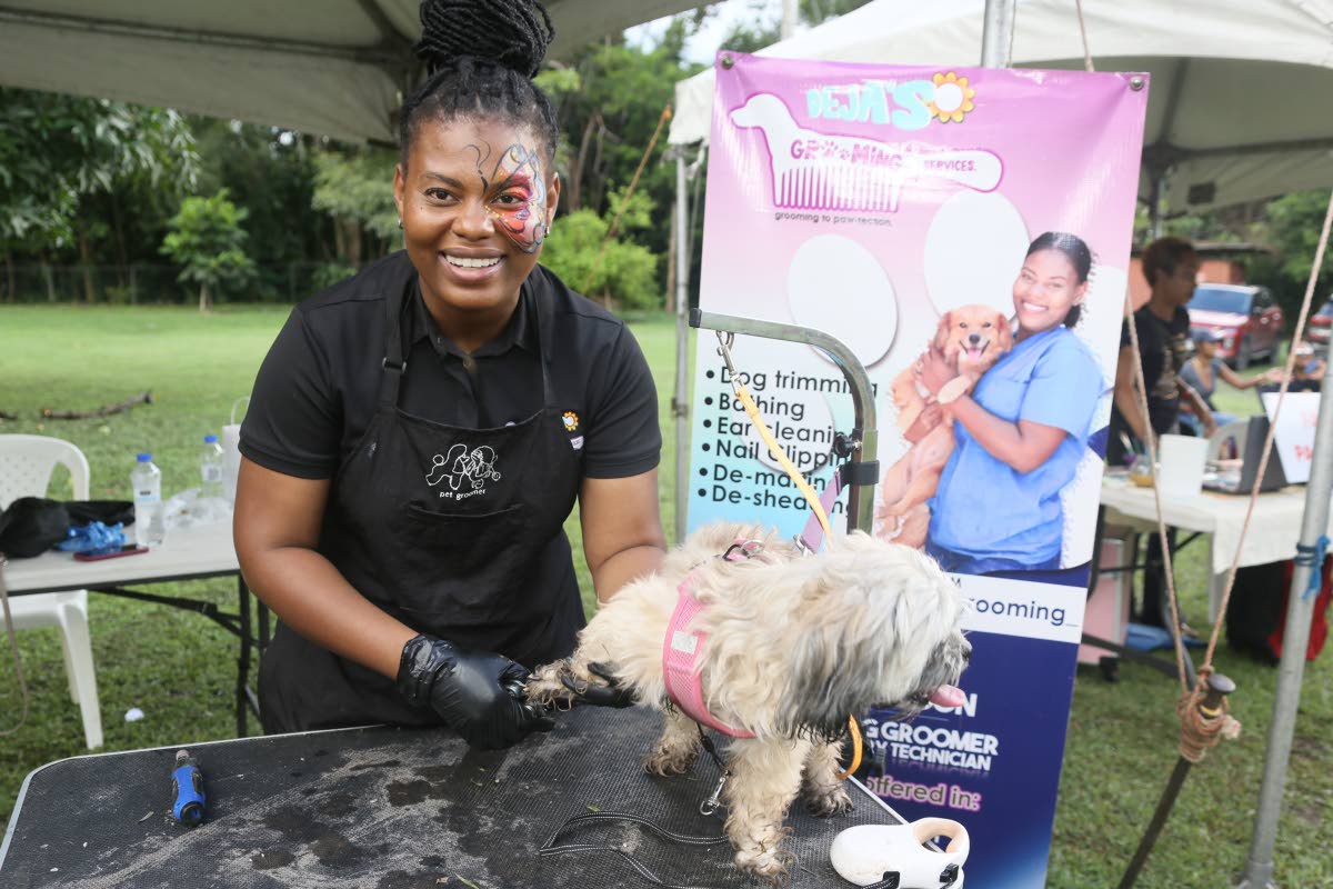 Deja Gordon, the mobile groomer and veterinary technician behind Deja’s Grooming Services, is all smiles with her furry client, Bella.