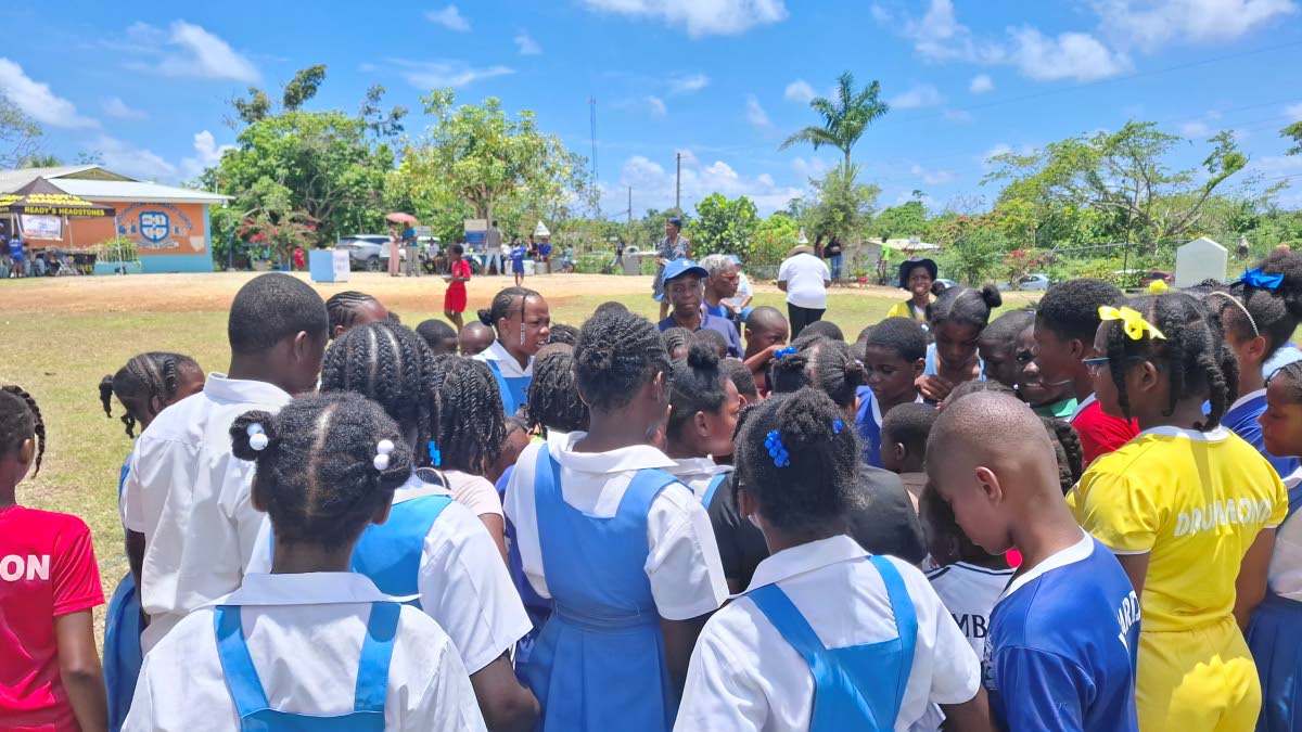 The students huddle together, eager to hear the instructions for the next activity for National Jamaica Moves day after reenergising. 
