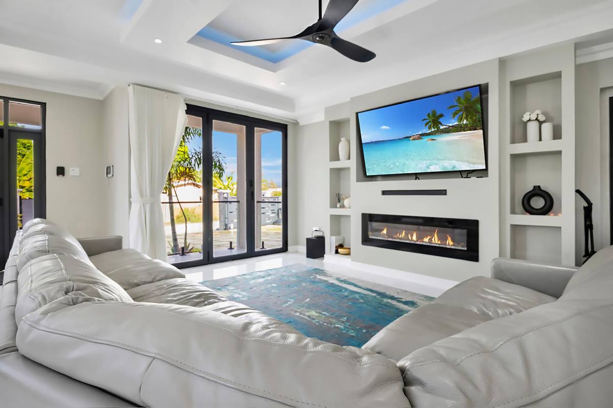 The living area features a fireplace and leads out to the pool.