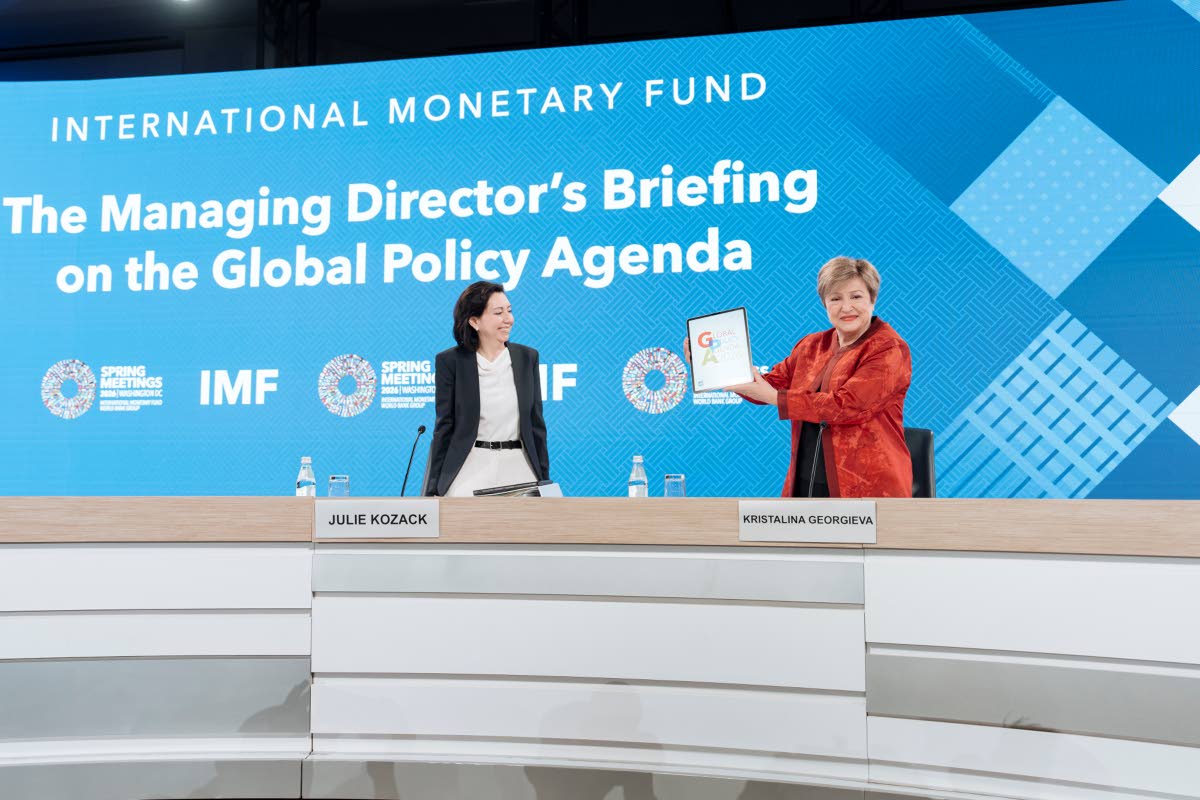 Managing Director Kristalina Georgieva holds up a digital copy of the IMF’s Global Policy Agenda report as Communications Department Director Julie Kozack looks on ahead of a press briefing during the 2026 Spring Meetings of the International Monetary Fu