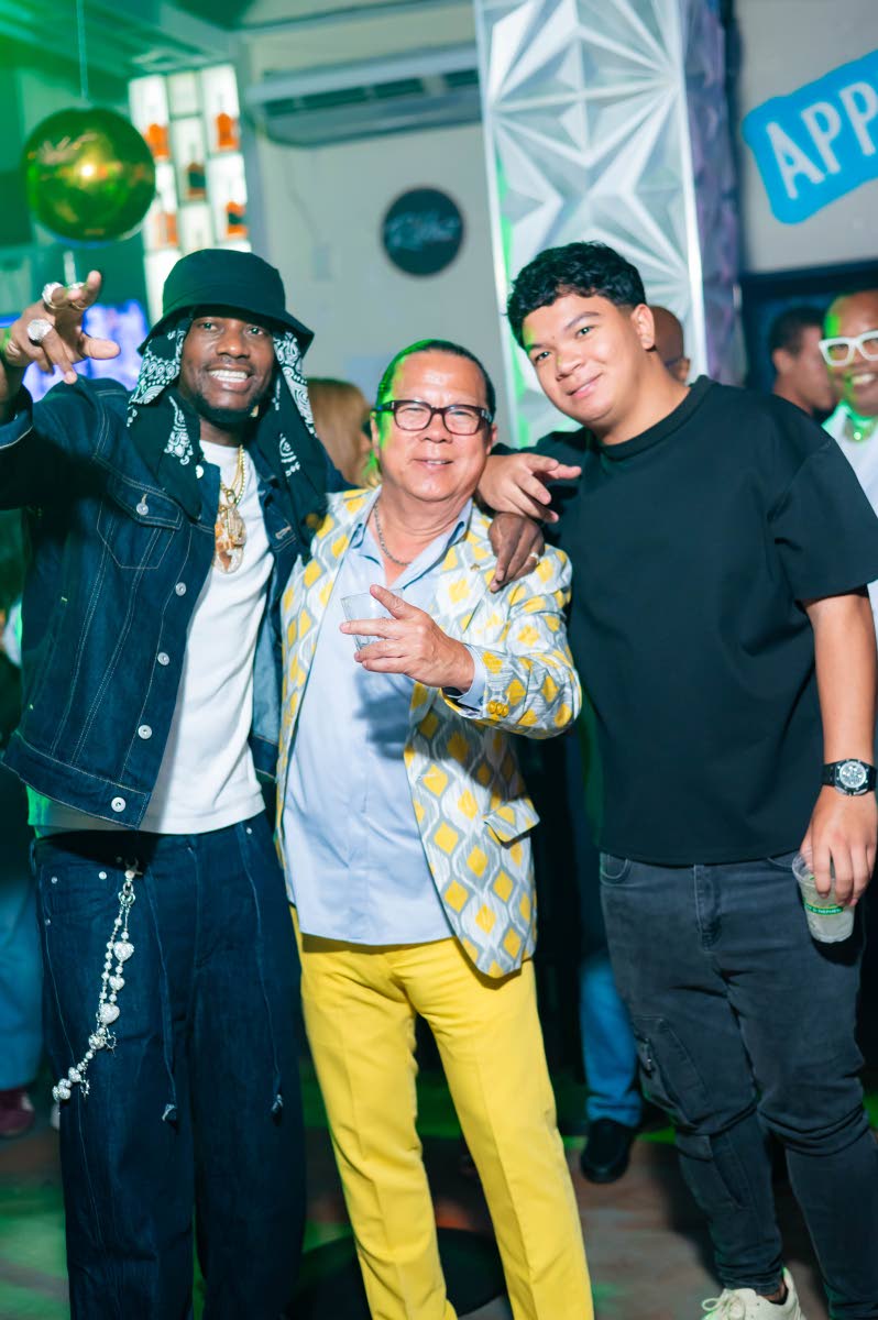 Veteran dancehall artiste Ding Dong (left) stopped for a photo with the birthday boss Brian ‘Ribbie’ Chung (centre) and his son Tyler at Ribbie’s birthday celebration on Thursday.