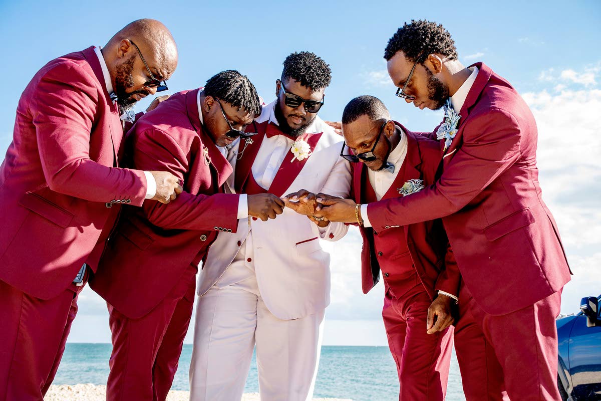 The groom (centre) shows off his wedding band while his groomsmen (from left) Amoyo Bryan; Rasheed Bryan, best man; Adrian Boucher; and Odane Bolton look on.