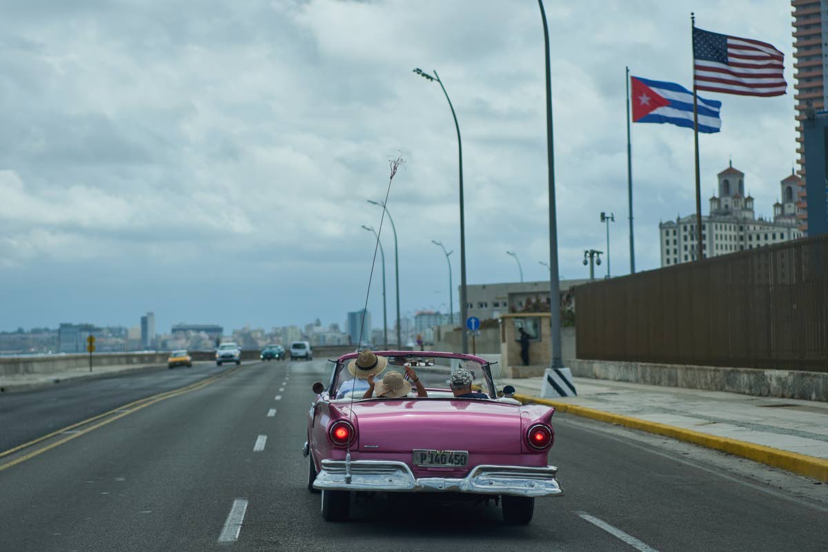 A classic American car carries tourists past the US Embassy in Havana, Monday, April 20, 2026. (AP Photo/Ramon Espinosa)