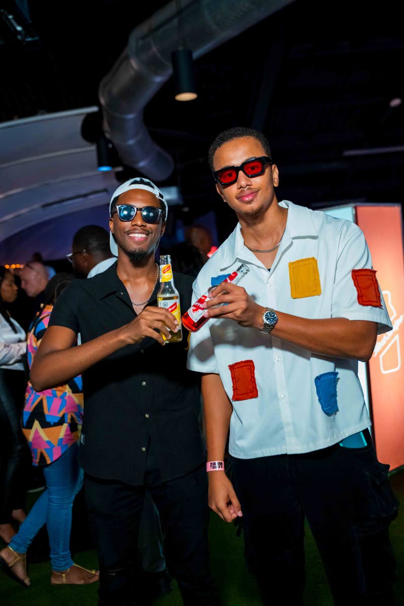 Content creators Walter Grant Jr (left) and Adam Bogle share a toast in honour of the night’s celebrations.