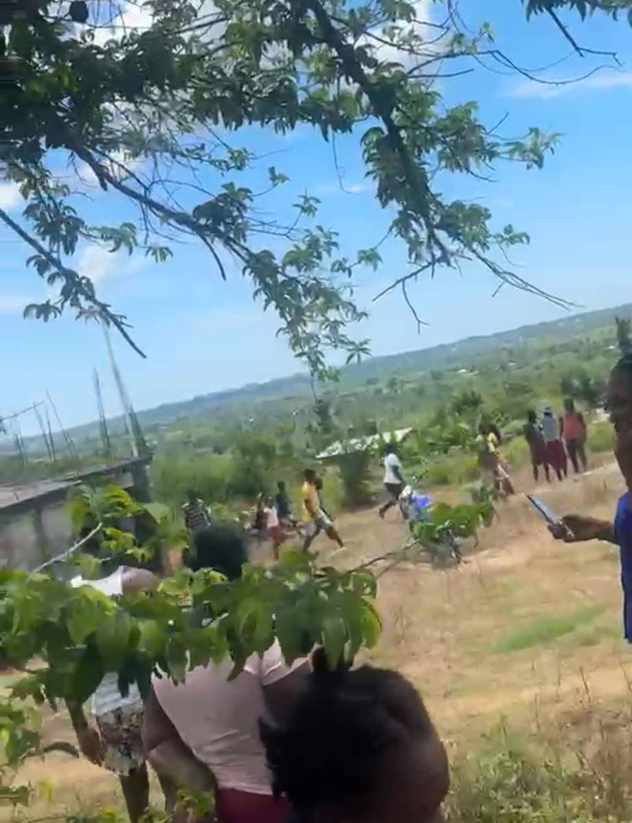 Residents of Mountainside in St Elizabeth converge at the home where the fatal stabbing occurred on Tuesday.