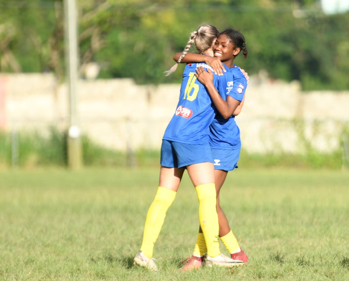 Monica Bosiljevac of Real Mona FC (left) is embraced by her teammate Alexia Evans after scoring a goal during the Jamaica Women’s Premier League fixture against UWI women’s FC at UWI Mona Bowl on Saturday.