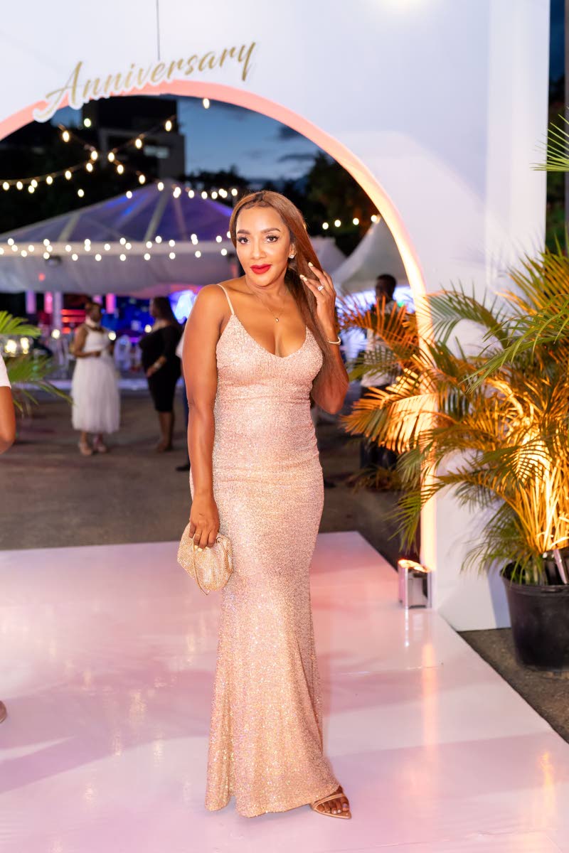 Singer and songwriter Sandy Smith D’ascola shimmers in a sequinned champagne gown.