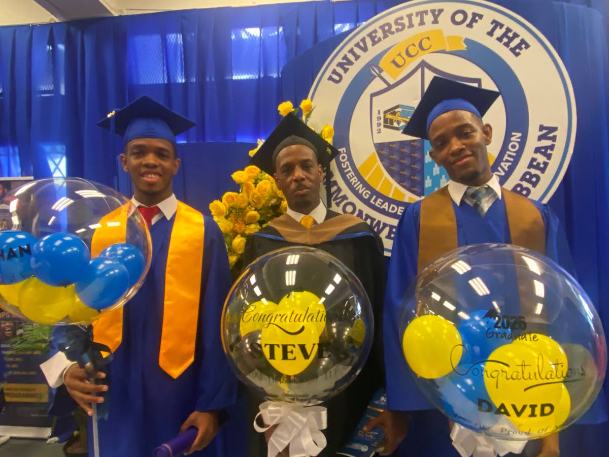 Steve Mitchell flanked by his sons Jonathan (left) and David at their graduation ceremony at the National Arena 