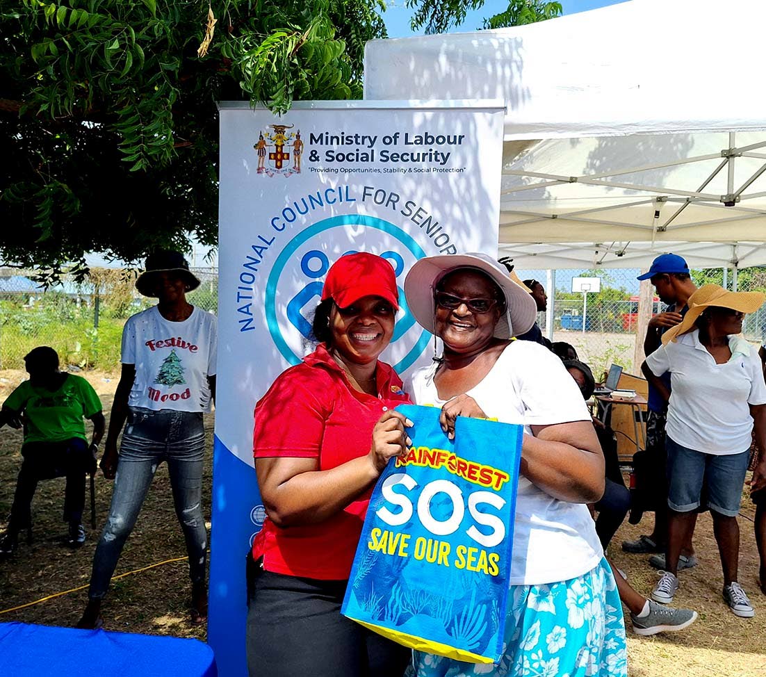 Leith Parkinson, 65, of Longville Park accepts her prize from Oneika Miller, branch manager at Rainforest Seafood’s Old Harbour location in St Catherine, after placing first in the ska competition.