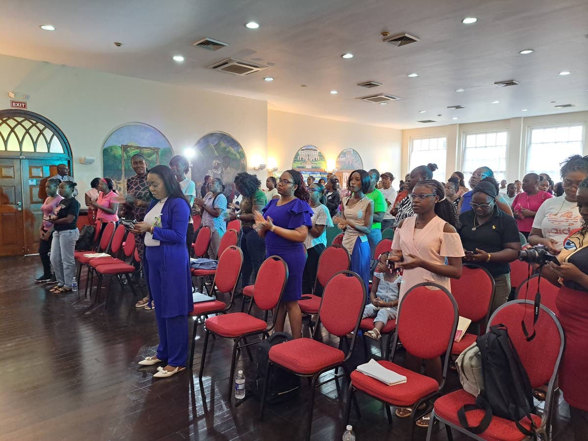 Attendees at the Social Development Commission’s inaugural Montego Bay Women’s Empowerment and Opportunity Fair, take part in devotional activities during the event, which was held at the Montego Bay Cultural Centre in Sam Sharpe Square on Thursday.