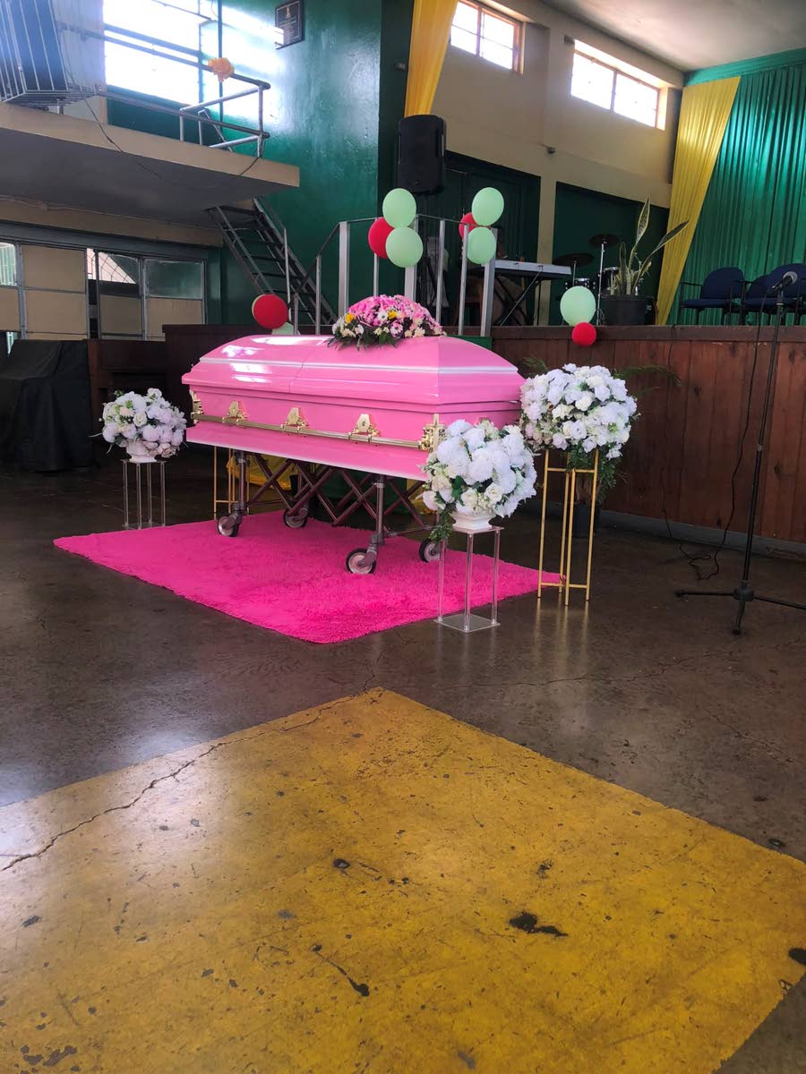 Kemelia Paul's coffin inside the Excelsior High School auditorium in Kingston yesterday.