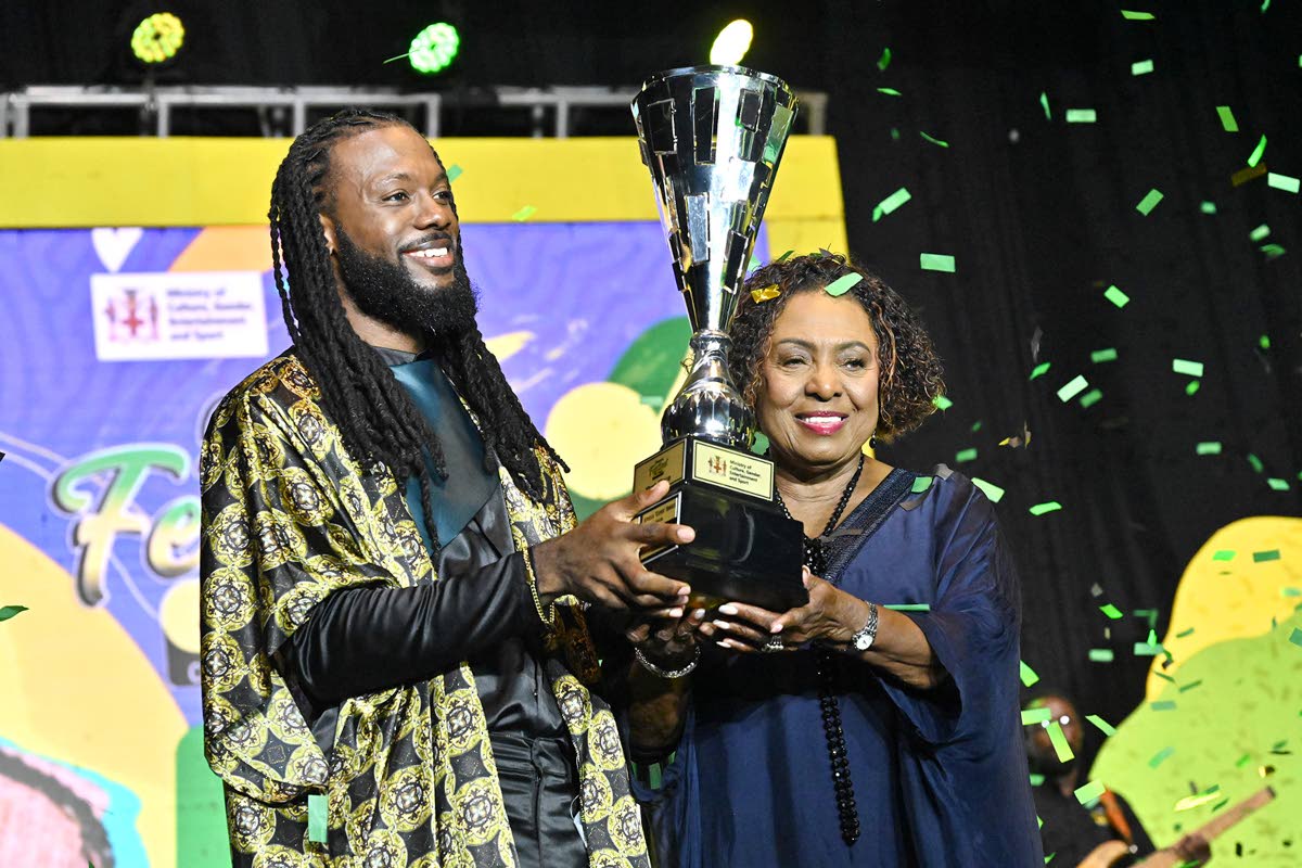  Minister of Culture, Gender, Entertainment and Sport Olivia ‘Babsy’ Grange, presents the winning trophy to dBURNZ.