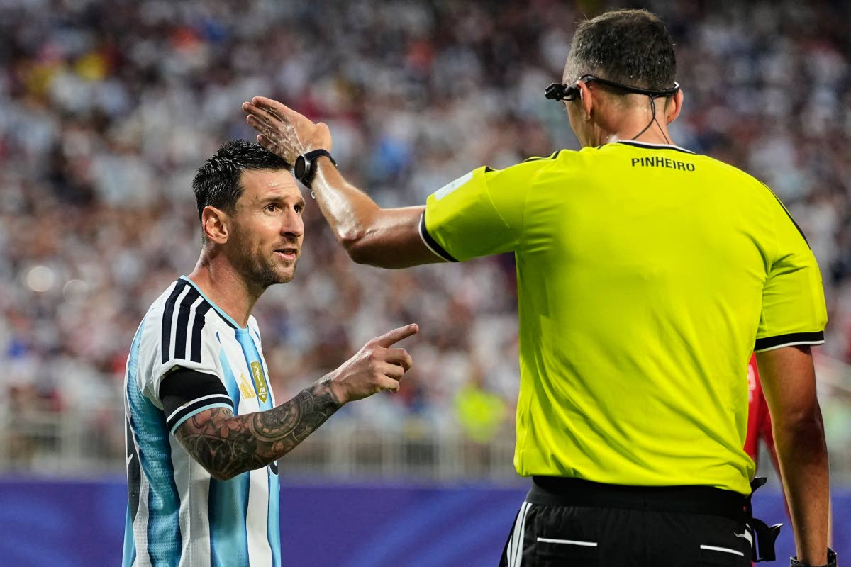 Argentina's Lionel Messi, left, talks to referee Joao Pinheiro, of Portugal, during the World Cup quarterfinal soccer match against Switzerland in Kansas City, Mo., Saturday, July 11, 2026. (AP Photo/Charlie Riedel)