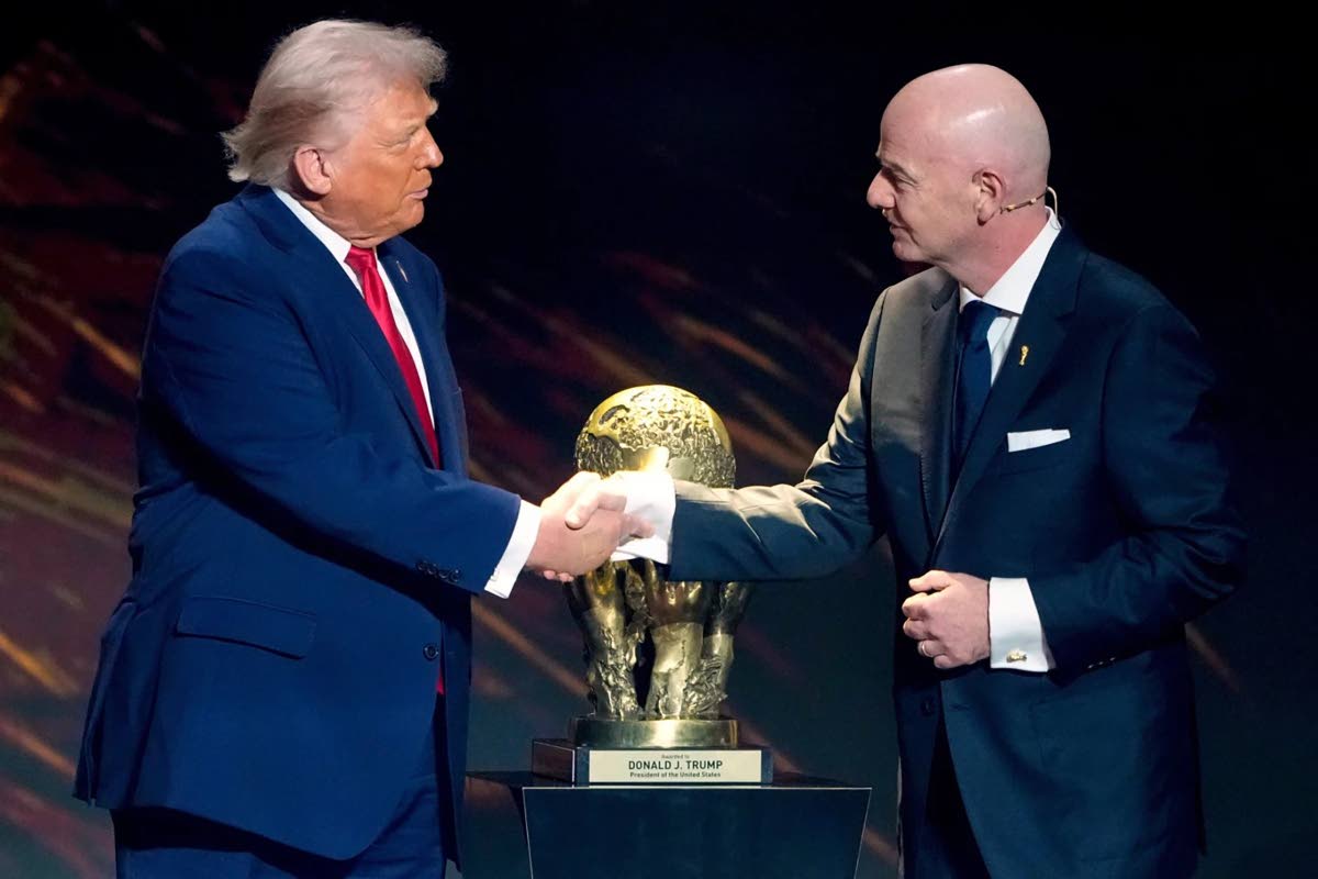 FIFA President Gianni Infantino (right) awards President Donald Trump with the FIFA Peace Prize during the draw for the 2026 soccer World Cup at the Kennedy Center in Washington, on December 5, 2025.