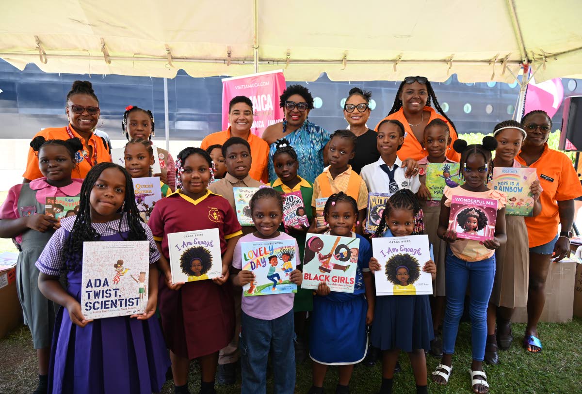 Sarah’s Children Chairman Janet Silvera and Odette Dyer, regional director of the Jamaica Tourist Board, share lens time with Festival at Sea representatives and students from.schools across western Jamaica during the donation of books at Historic Falmou