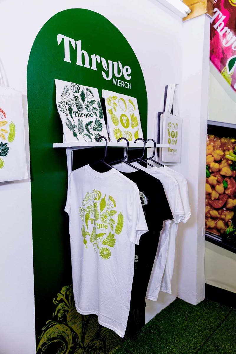 Custom-branded merchandise forms part of Kimberley Jones’ Thryve Foods brand identity, presented during the Edna Manley School of Visual Arts’ exhibition for final-year students.