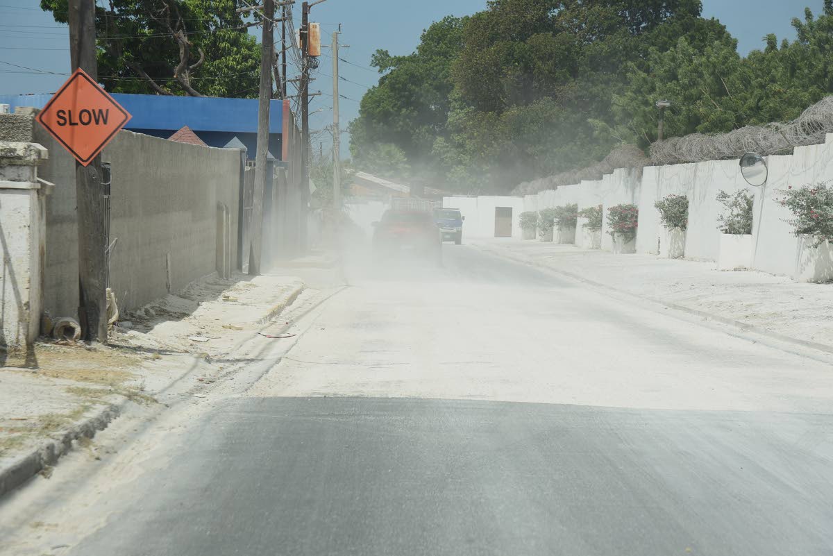 A section of Vineyard Road in Vineyard Town, St Andrew, that is left to be asphalted, is causing a dust nuisance to residents of the area from motorist who refuse to slow down while driving through the area.