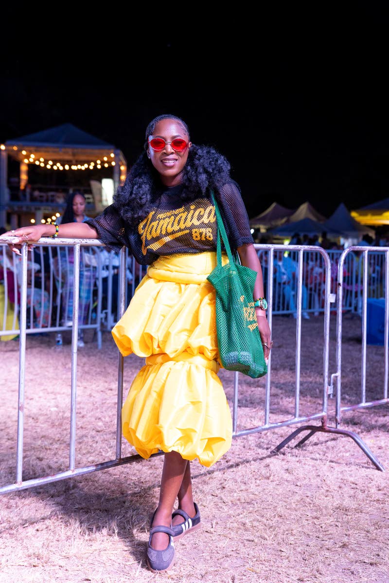 Monique McLeggon, Christian fashion and lifestyle influencer, pairs a RepJa bag and shirt with a yellow tiered skirt made by IM Fashion.