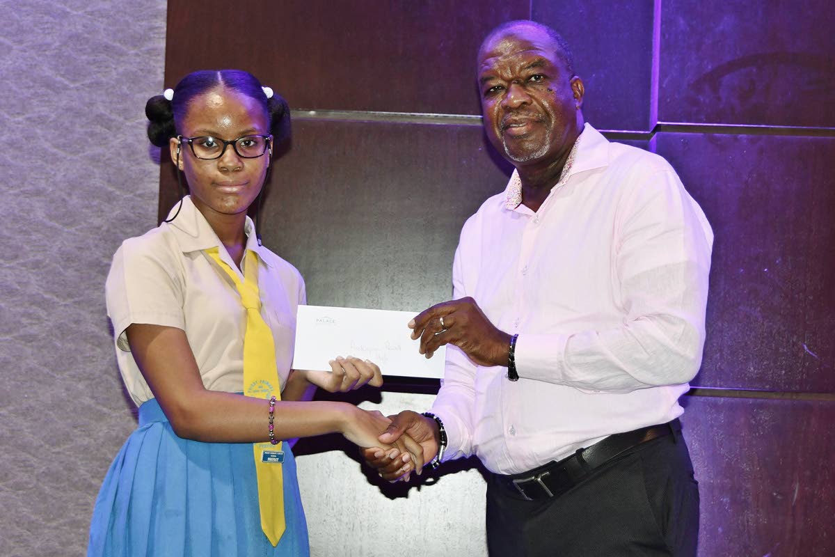 Rickaysia Powell accepts her grant from Moon Palace Vice-President Clifton Reader. Powell, a graduate of Priory Primary School in St Ann, will begin studies at Iona High School in September.