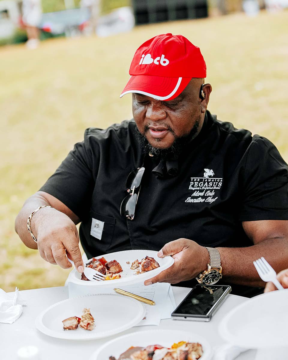 Mark Cole, executive chef at The Jamaica Pegasus hotel and chief judge of the Walkerswood Jerk Competition, prepares to sample jerk chicken cooked by one of the contestants.