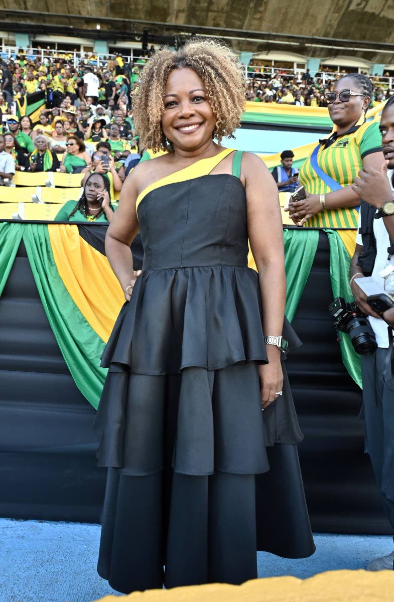 Senator Dr Dana Morris Dixon, minister of education, skills, youth and information, wears a tiered dress with a yellow-and-green strap detailing.