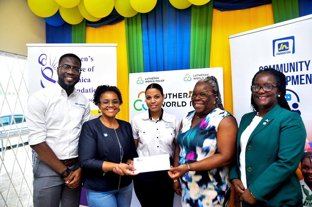 Claudine Allen (second left), general manager of the JN Foundation, presents a cheque to Charmaine McKenzie (second right), acting director of field operations at the Women’s Centre of Jamaica Foundation. Sharing in the moment are Omar Wright (left), lea