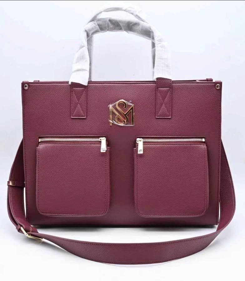 The rich burgundy SM Kollection Tote delivers a statement-making addition to the latest drop, bringing depth and sophistication to the brand’s signature design.
