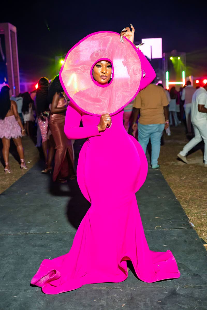 Crystal Towanna-Newman makes a dramatic entrance at Milk & Honey in a magenta, floor-length gown by Dianne of Orlando, Florida. The look turned heads with its sculptural silhouette, exaggerated hip detailing and statement headpiece.