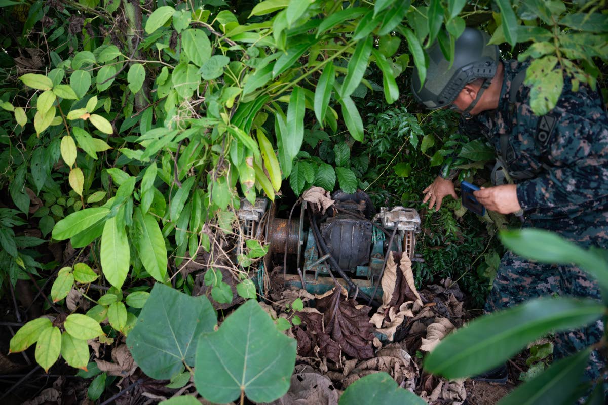 Peruvian Navy soldier discover a motor used for illegal mining near the Malinowski River in the Tambopata National Reserve.