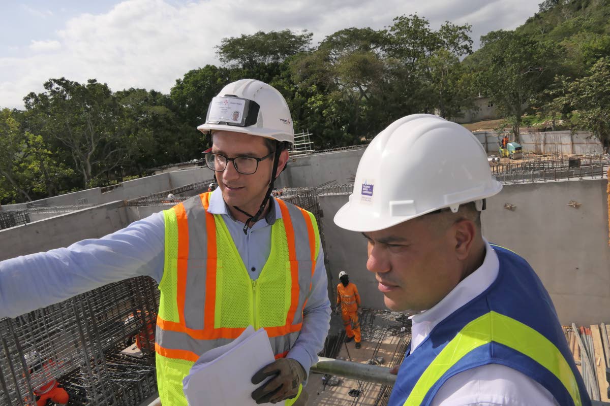 Thomas Savary (left), project manager at VINCI Construction Grands Projets, shows Matthew Samuda, minister of water, environment and climate change, the work being carried out at the Rio Cobre Water Treatment Plant in Content, St Catherine.