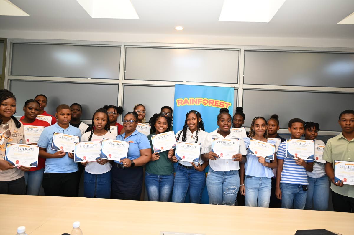 Primary, secondary and tertiary students, all children of Rainforest employees, pose for a photograph after receiving certificates during an awards presentation at Rainforest’s headquarters in Montego Bay on Tuesday. 