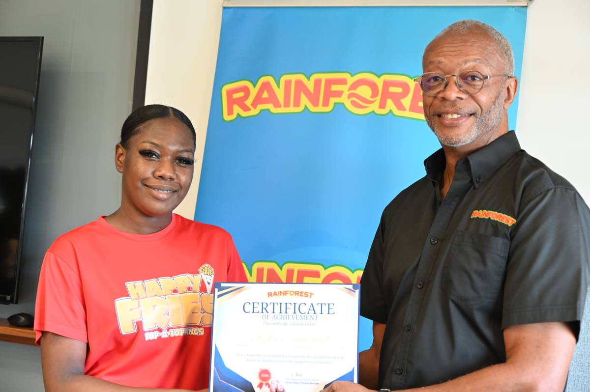 General Manager of Rainforest Caribbean Jerome Miles (right) presents a certificate to Kyla Crawford, who is pursuing studies in dentistry in Cuba.