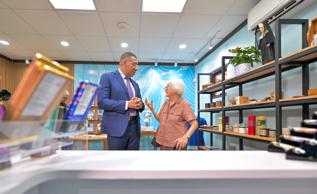 Prime Minister Dr Andrew Holness (left), in conversation with Sister Grace Yap, Order of St. Francis (OSF), in the gift shop of the newly opened Alpha Mercy Historical Centre. 