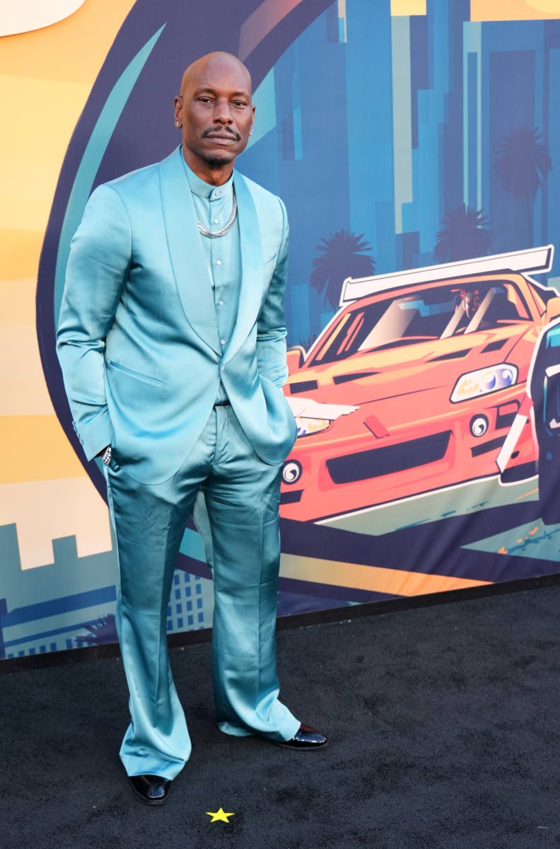 Tyrese arrives at the 25th anniversary celebration screening of ‘The Fast and the Furious’ in a light-blue satin shawl-collar suit paired with a matching shirt.