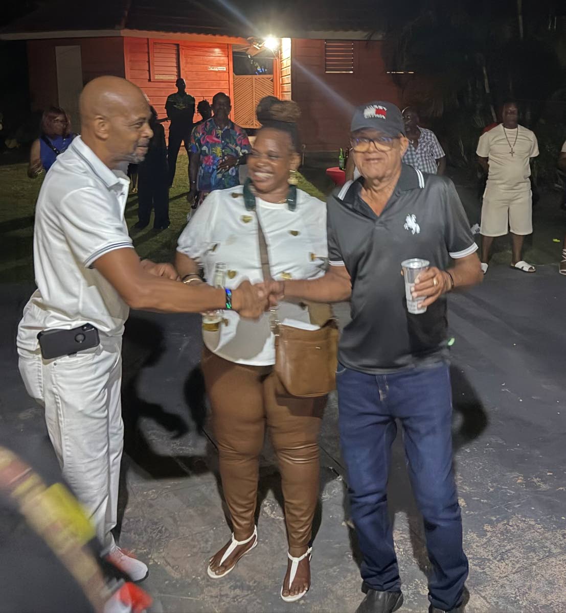 Promoter of the inaugural Original Shed Reunion Retro Party, Michael Seivwright, is greeted by Paul Brown (left) at the historic Martha Brae Water Wheel on August 5, 2026. At centre is Sherene Scott.